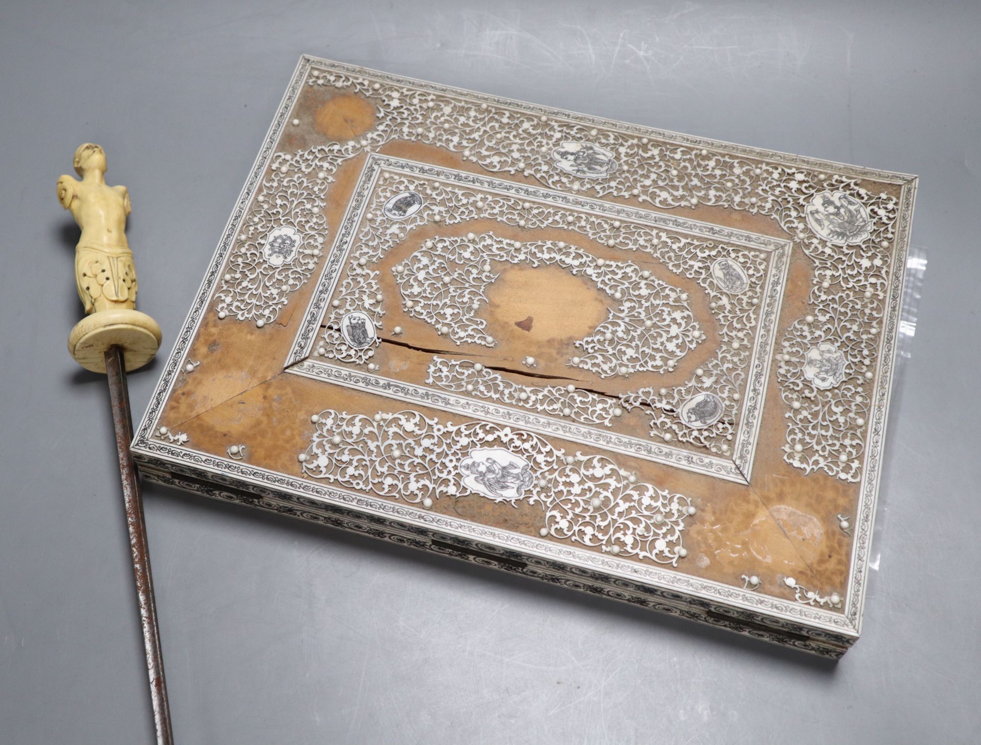 An 18th century German or Italian ivory hilt and guard and a 19th century Southern Indian ivory and sandalwood blotter pad